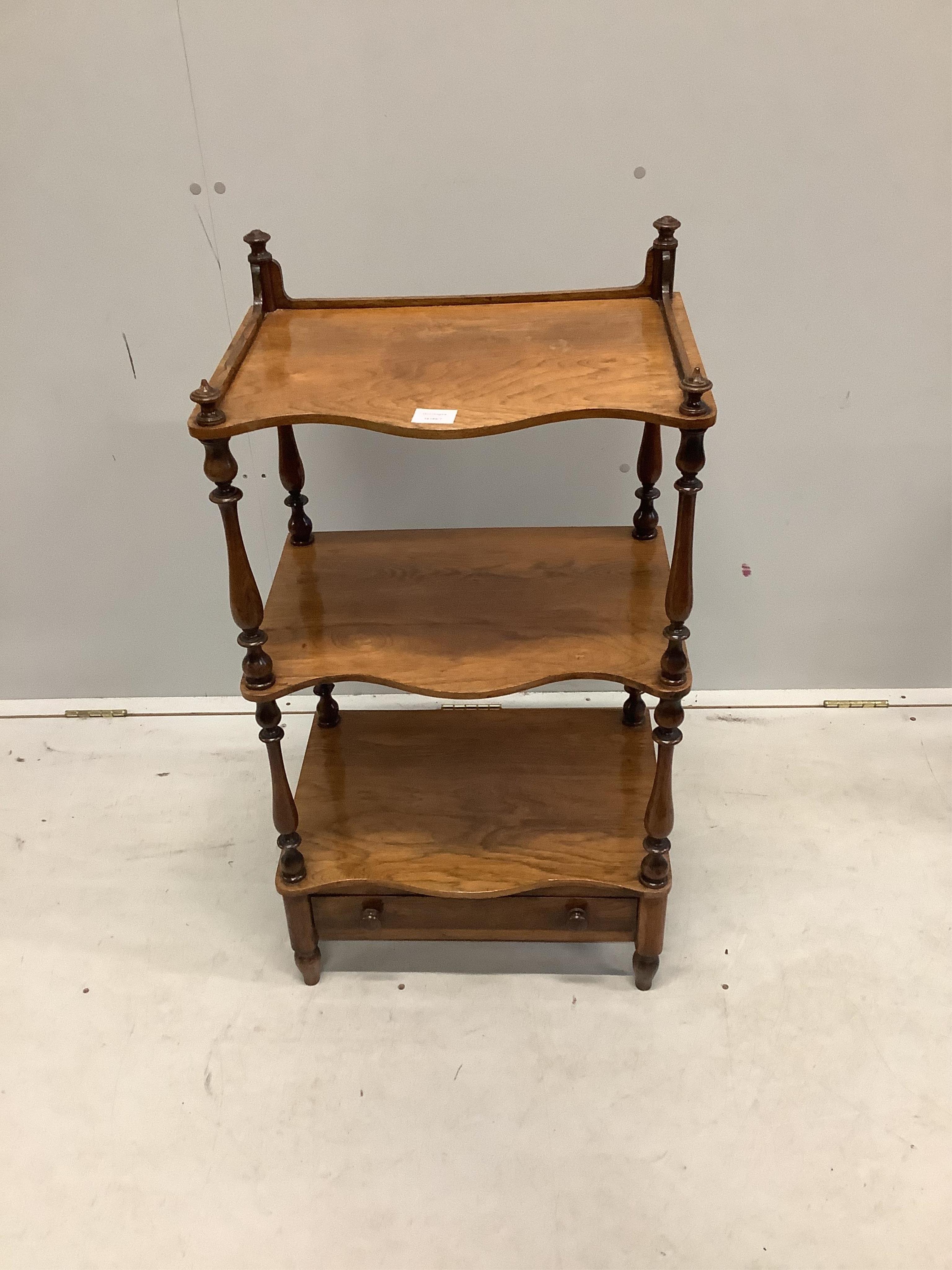 An early Victorian rosewood serpentine front three tier whatnot, width 50cm, depth 35cm, height 92cm. Condition - fair to good